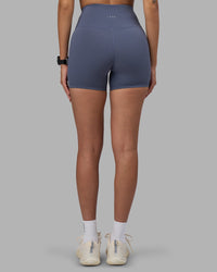 Woman wearing Fusion Ultra High-Rise 4" Short - Night Shadow | Set:true | Angle:back | Model:Rhiley | Size:S
