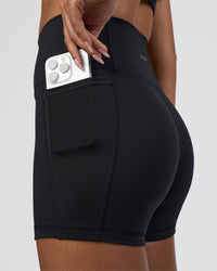 Woman wearing Fusion Ultra High-Rise 4" Short Pockets - Black | Model:Ruby | Size:S