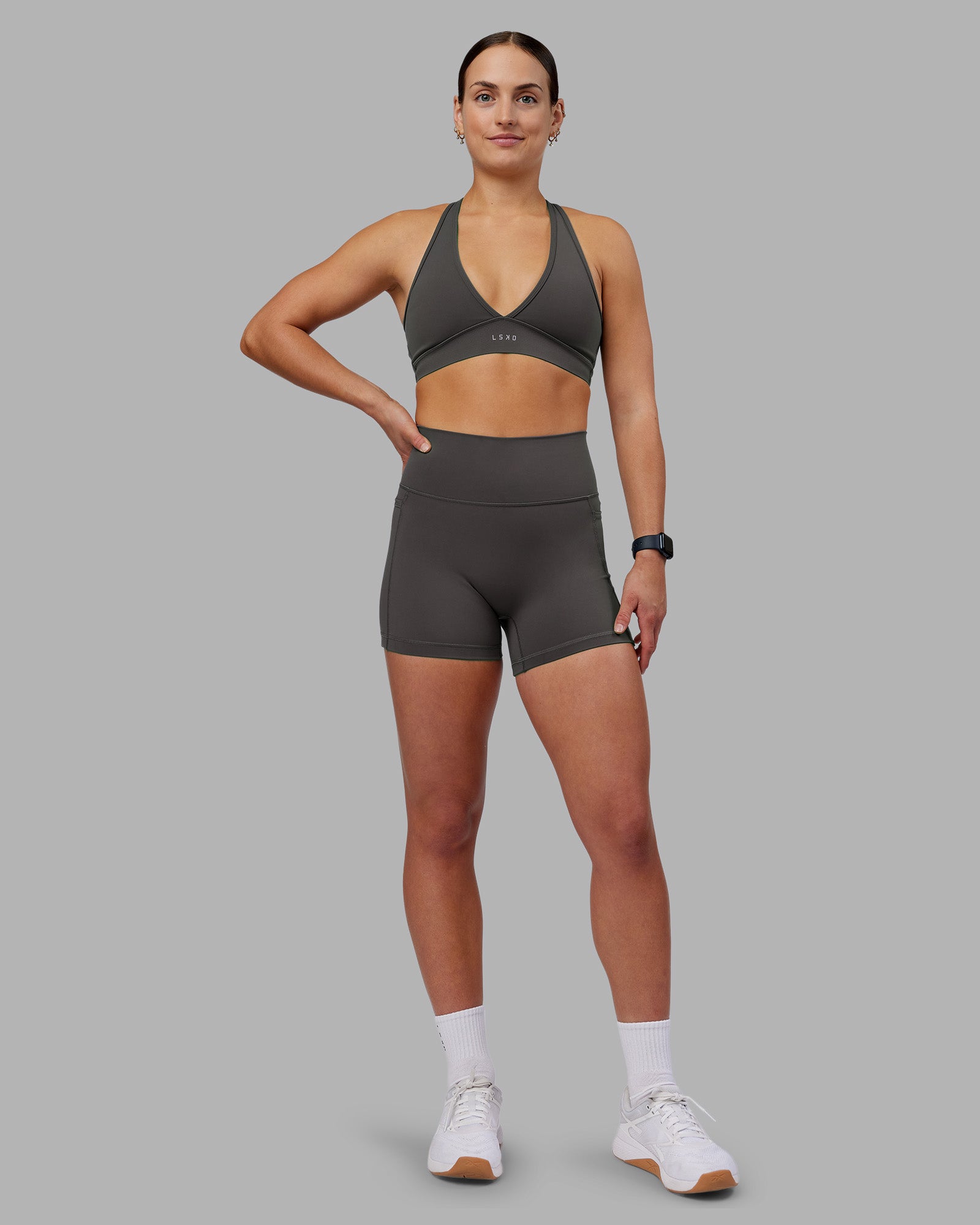 Woman wearing Fusion Ultra High-Rise 4" Short Pockets - Dark Storm | Model:Keisha | Size:S