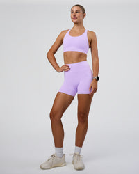 Woman wearing Fusion Ultra High-Rise 4" Short Pockets - Pale Lilac | Model:Emelia | Size:S