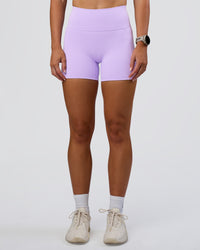 Woman wearing Fusion Ultra High-Rise 4" Short Pockets - Pale Lilac | Set:true | Angle:front | Model:Emelia | Size:S