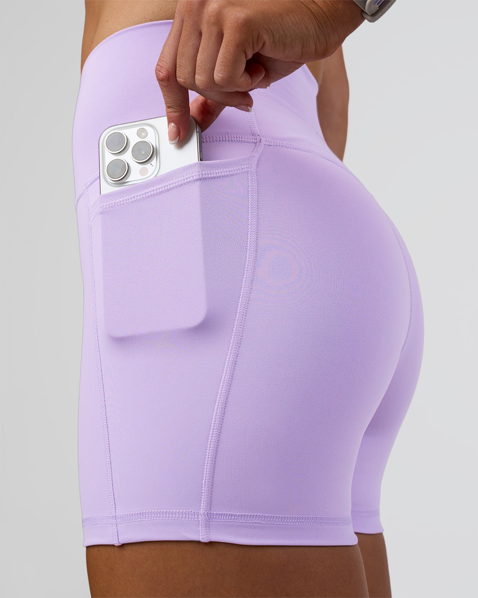 Woman wearing Fusion Ultra High-Rise 4" Short Pockets - Pale Lilac | Model:Emelia | Size:S