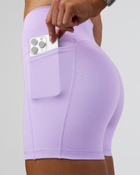 Woman wearing Fusion Ultra High-Rise 4" Short Pockets - Pale Lilac | Set:true | Angle:closeup | Model:Emelia | Size:S