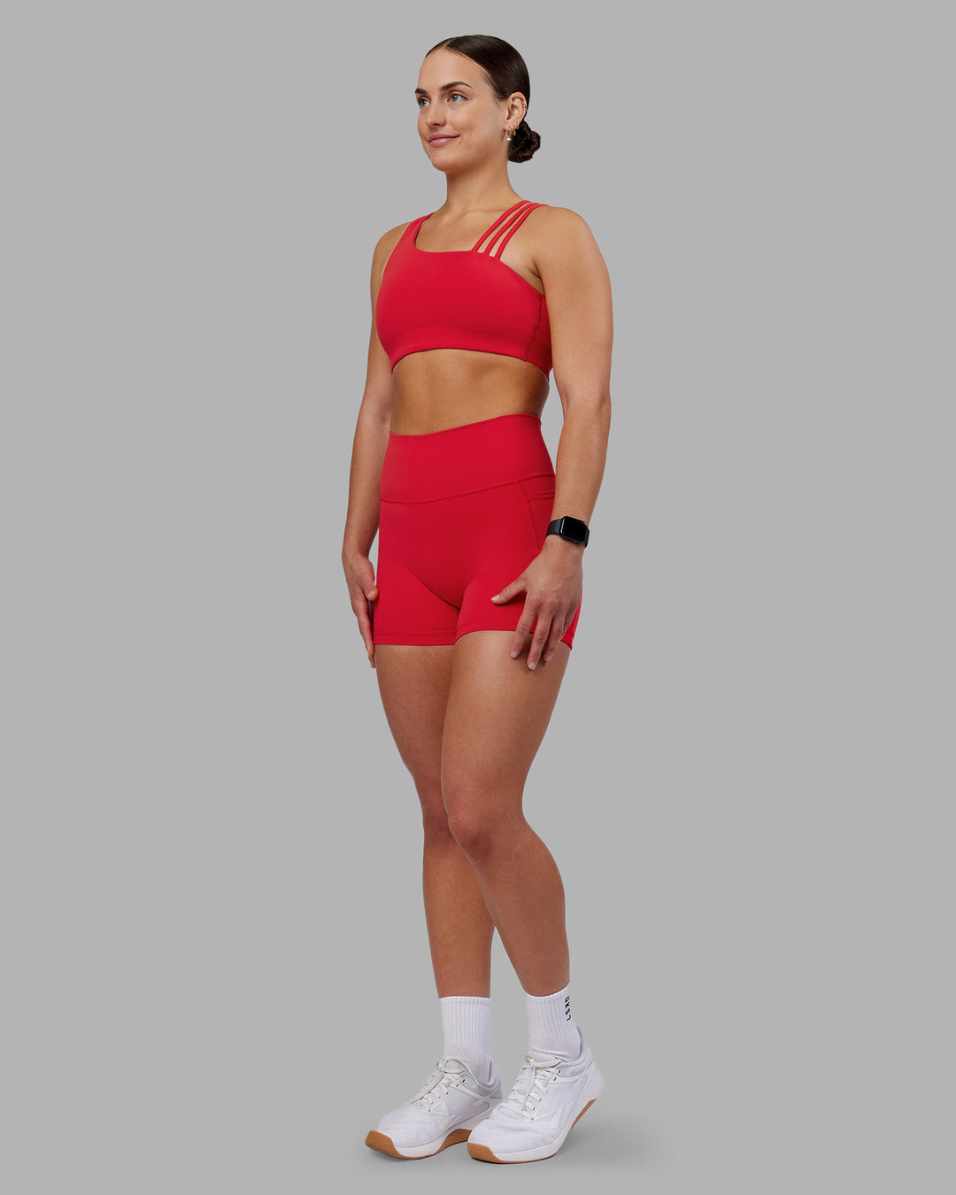 Woman wearing Fusion Ultra High-Rise 4&quot; Short Pockets - Scarlet | Model:Keisha | Size:S