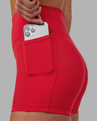Woman wearing Fusion Ultra High-Rise 4" Short Pockets - Scarlet | Set:true | Angle:closeup | Model:Keisha | Size:S