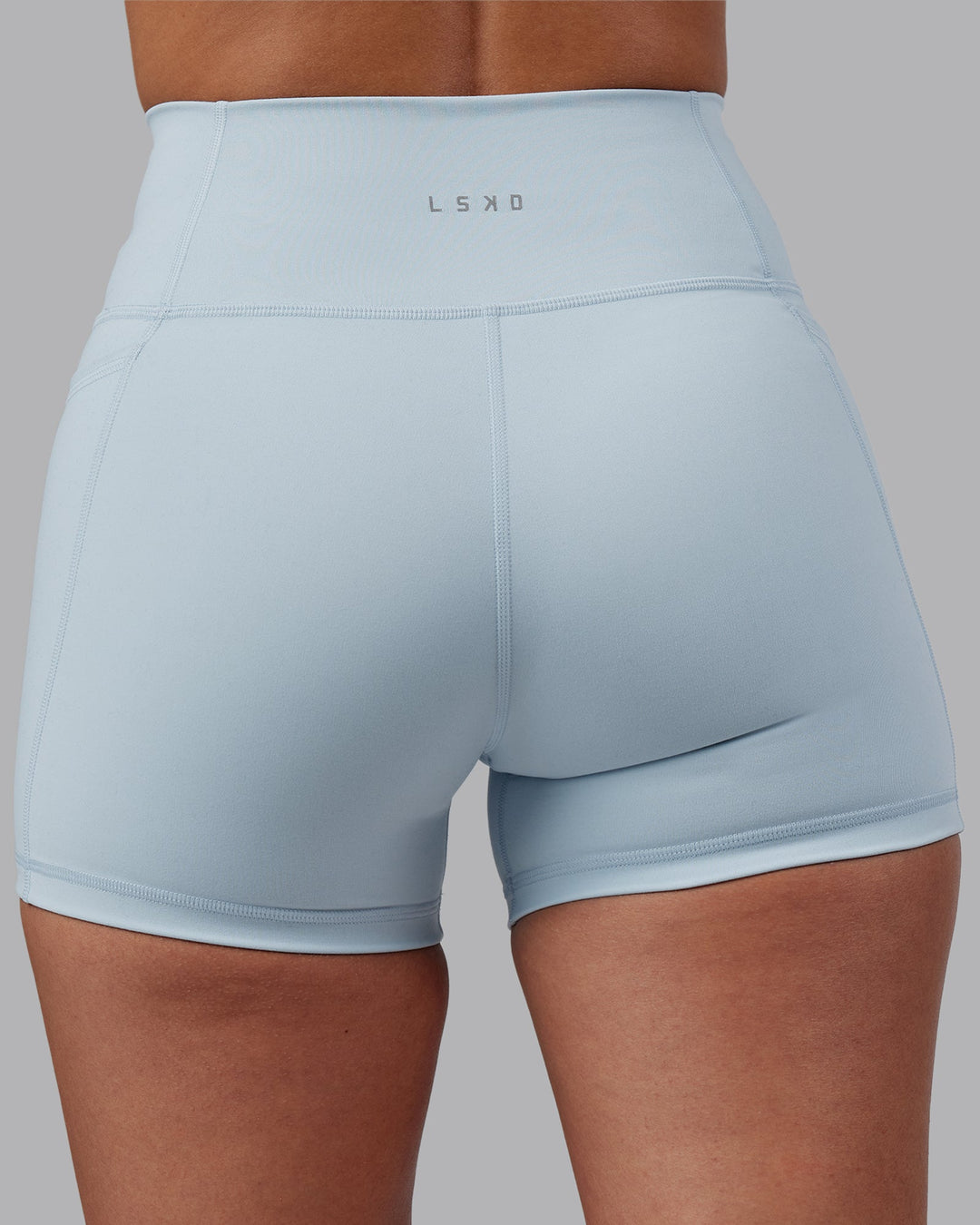 Woman wearing Fusion Ultra High-Rise 4&quot; Short Pockets - Skyride | Model:Rhiley | Size:S
