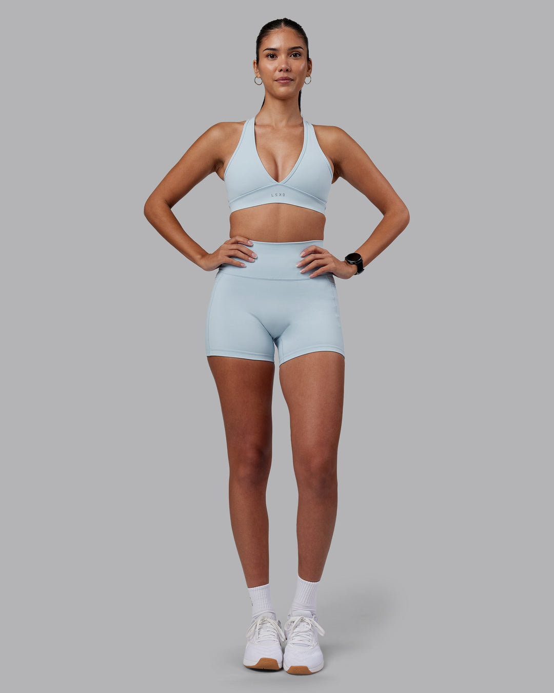 Woman wearing Fusion Ultra High-Rise 4&quot; Short Pockets - Skyride | Model:Rhiley | Size:S