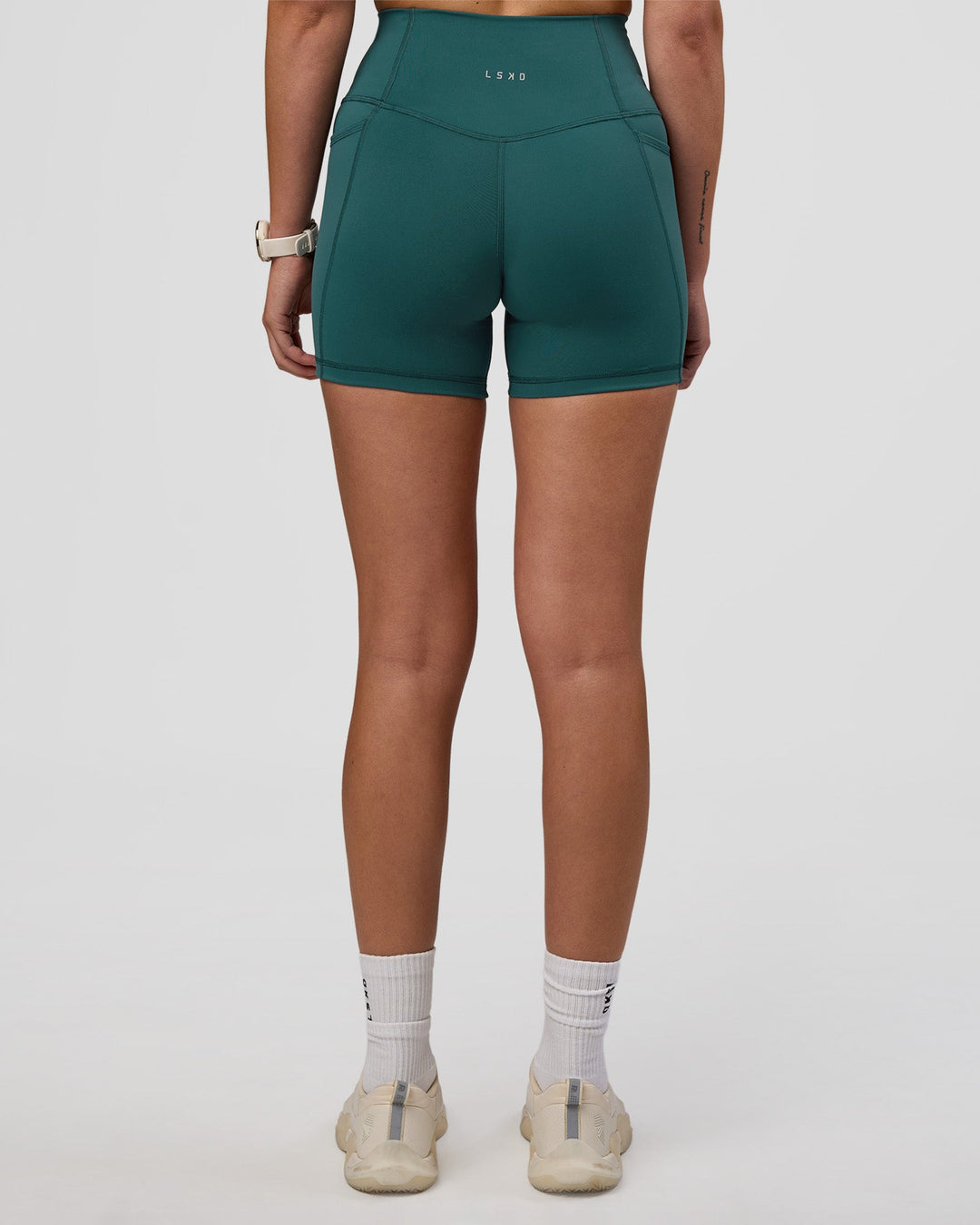 Woman wearing Fusion Ultra High-Rise 4" Short Pockets - Transformative Teal | Model:Myrte | Size:S