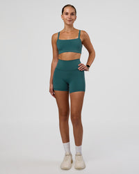 Woman wearing Fusion Ultra High-Rise 4" Short Pockets - Transformative Teal | Model:Myrte | Size:S