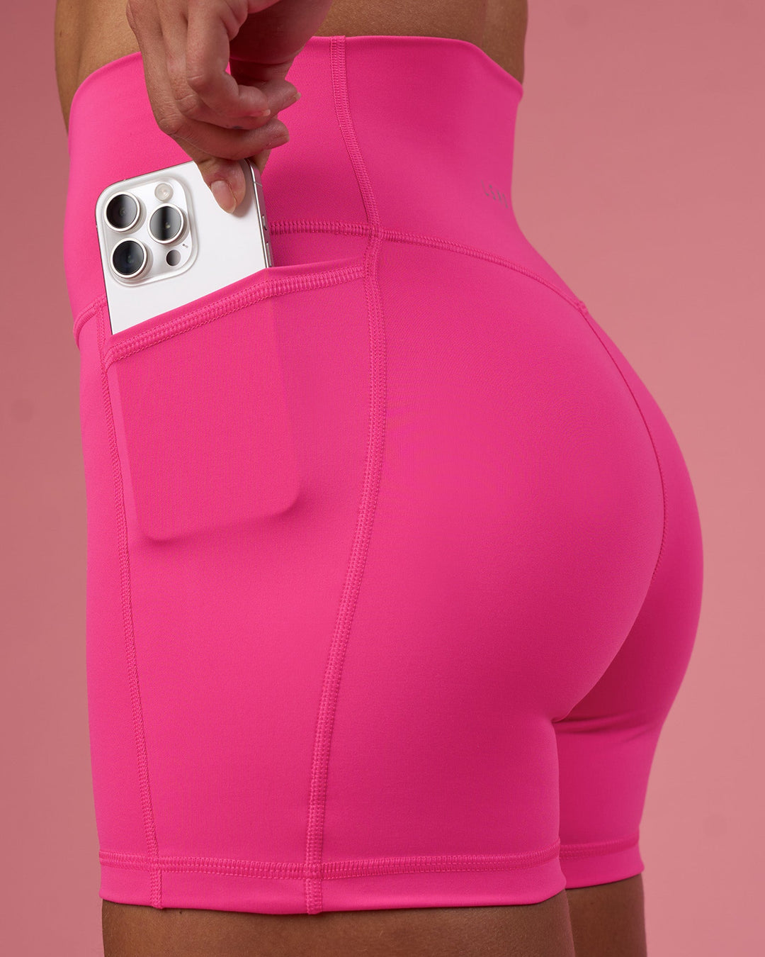 Woman wearing Fusion Ultra High-Rise 4&quot; Short Pockets - Ultra Pink | Model:Hannah | Size:S