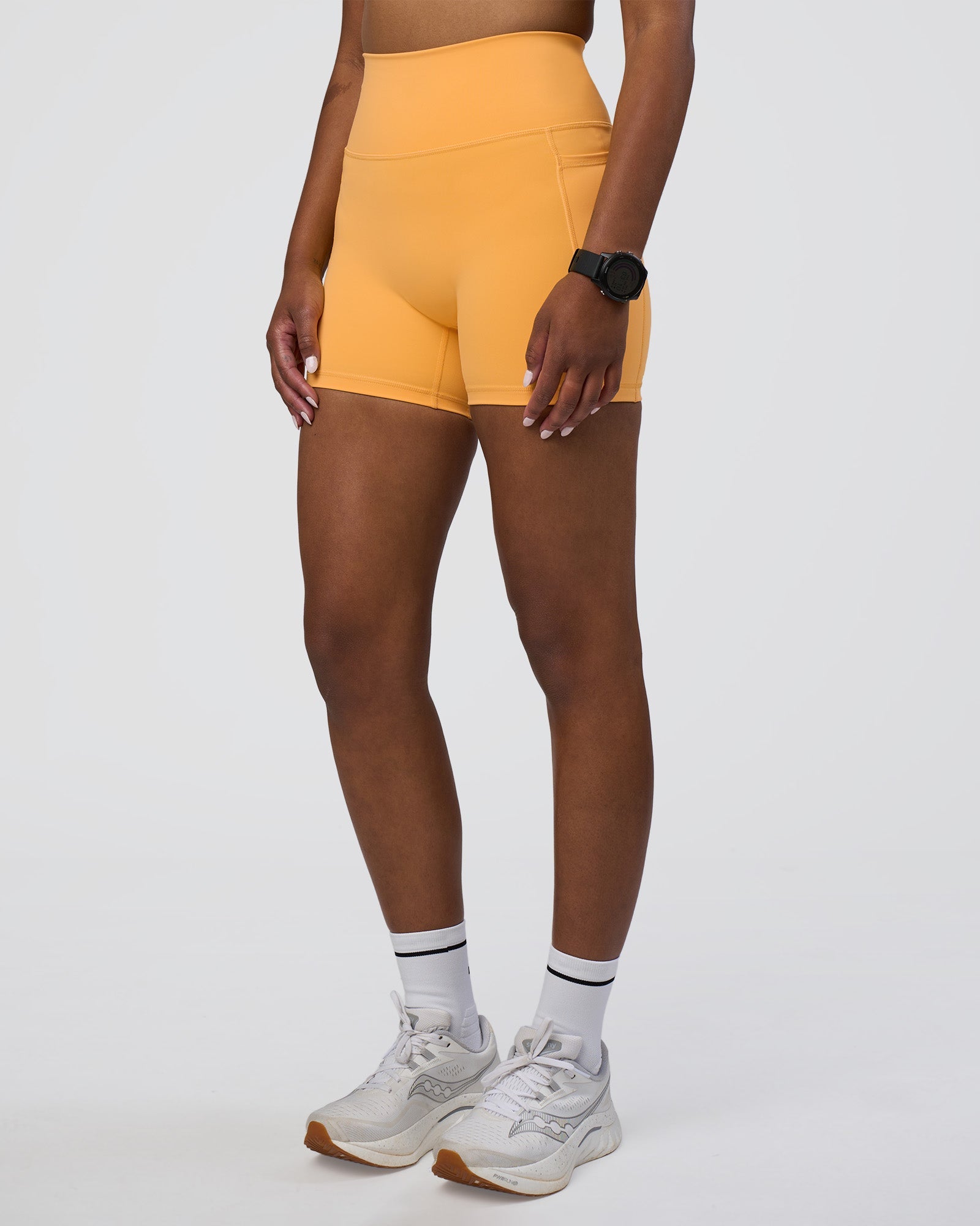 Woman wearing Fusion Ultra High-Rise 4" Short Pockets - Warm Apricot | Model:Rica | Size:S
