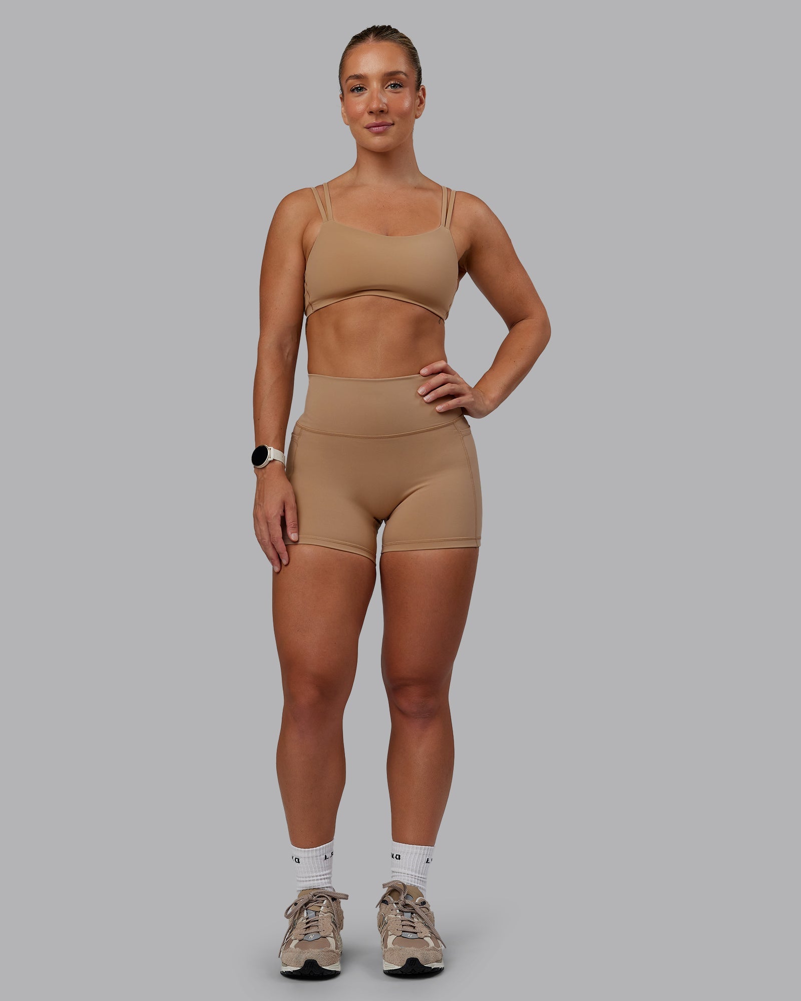 Woman wearing Fusion Ultra High-Rise 4" Short Pockets - Warm Smoke | Model:Lyss | Size:S
