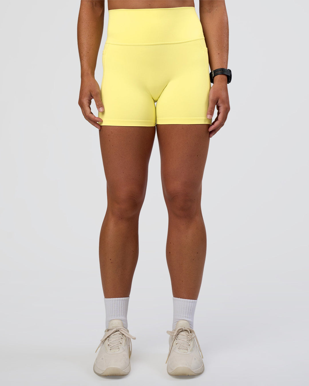 Woman wearing Fusion Ultra High-Rise 4&quot; Short Pockets - Yellow Fizz | Model:Sav | Size:S