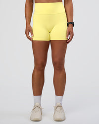 Woman wearing Fusion Ultra High-Rise 4" Short Pockets - Yellow Fizz | Set:true | Angle:front | Model:Sav | Size:S