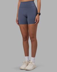 Woman wearing Fusion Ultra High-Rise 6" Short - Night Shadow | Set:true | Angle:side | Model:Rhiley | Size:S
