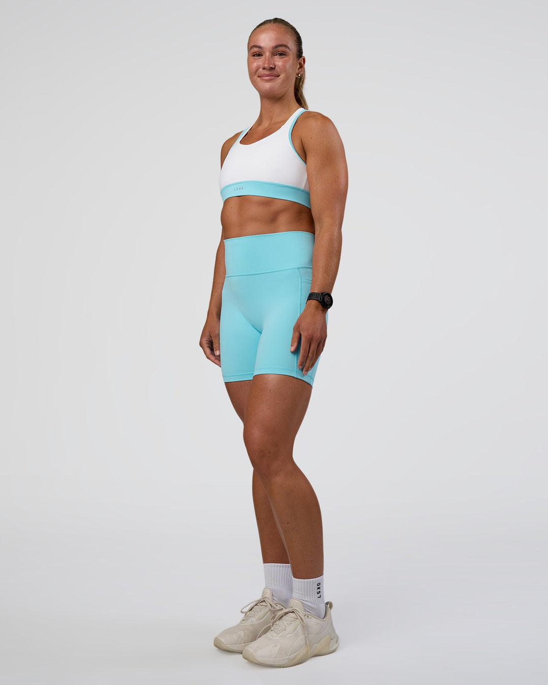 Woman wearing Fusion Ultra High-Rise 6&quot; Short Pockets - Baltic Sea | Model:Sav | Size:S