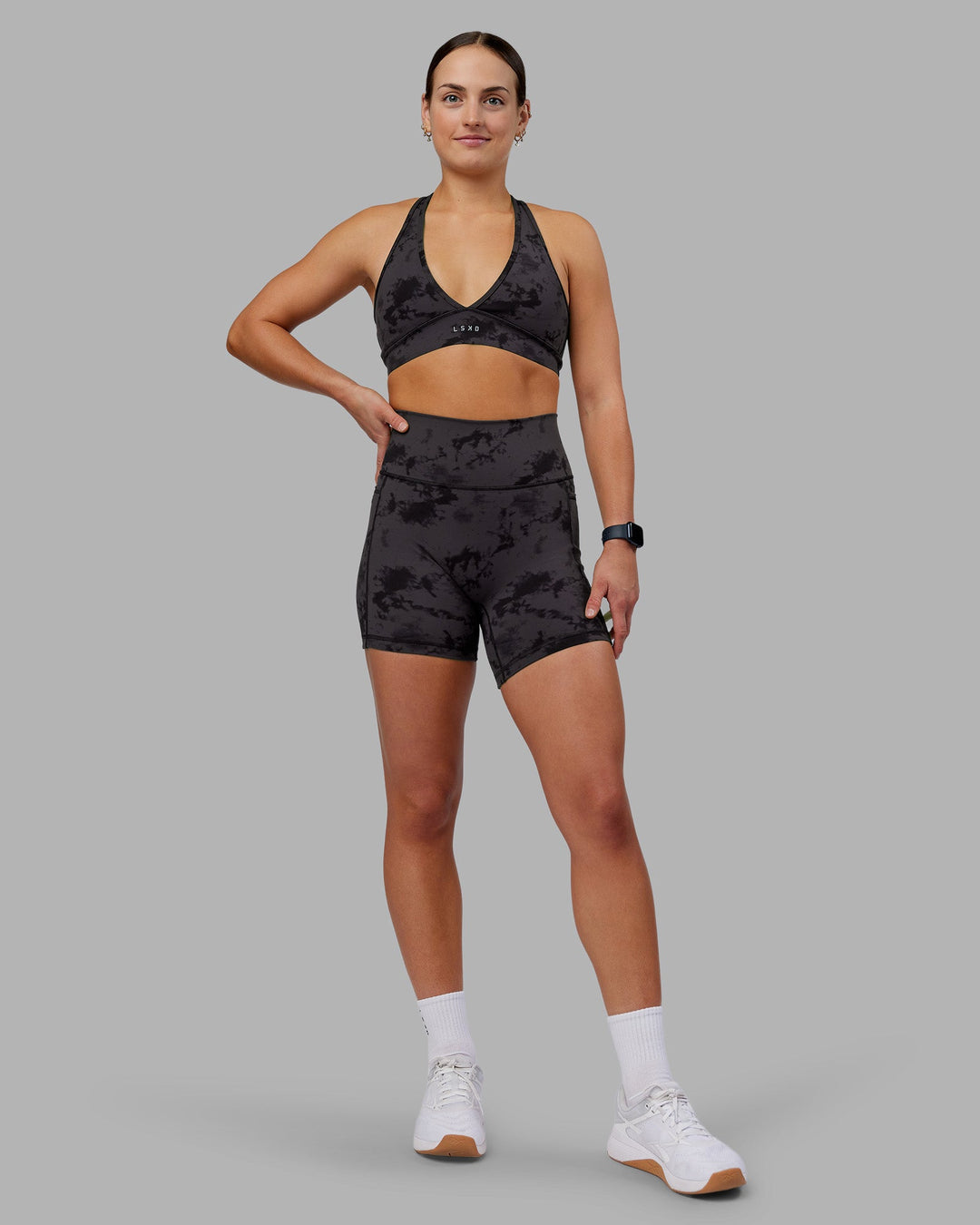 Woman wearing Fusion Ultra High-Rise 6&quot; Short Pockets - Black Tie Dye | Model:Keisha | Size:S