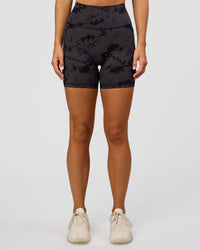 Woman wearing Fusion Ultra High-Rise 6" Short Pockets - Black Tie Dye | Set:true | Angle:front | Model:Amity | Size:S