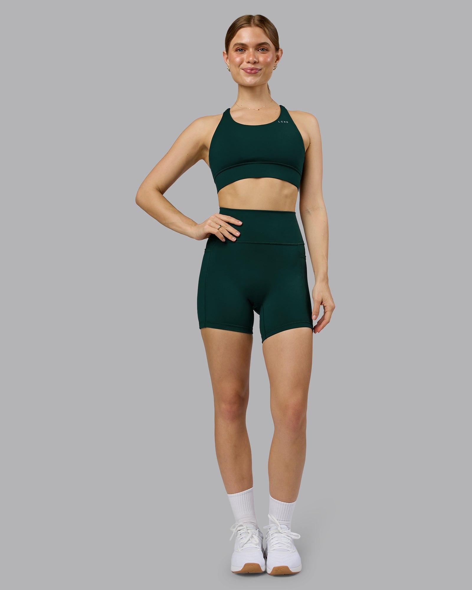 Woman wearing Fusion Ultra High-Rise 6" Short Pockets - Dark Moss | Model:Emilie | Size:S