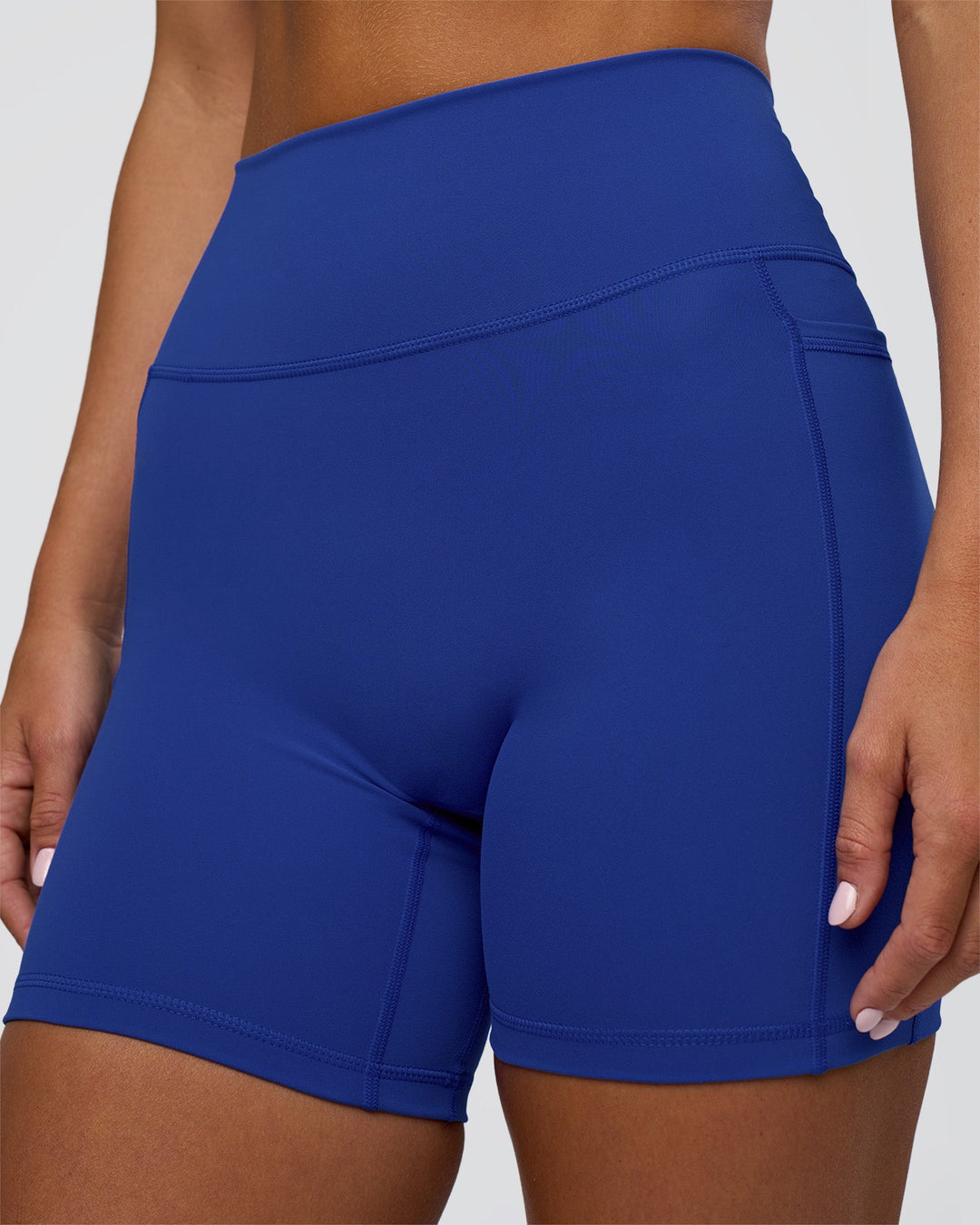 Woman wearing Fusion Ultra High-Rise 6" Short Pockets - Electric Indigo | Model:Amity | Size:S