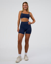 Woman wearing Fusion Ultra High-Rise 6" Short Pockets - Future Navy | Model:Amity | Size:S
