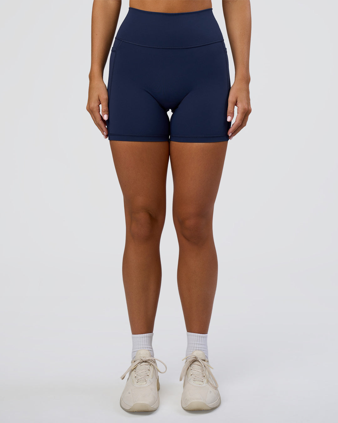 Woman wearing Fusion Ultra High-Rise 6&quot; Short Pockets - Future Navy | Model:Amity | Size:S
