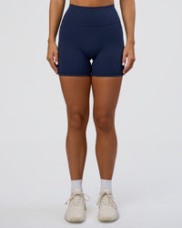 Woman wearing Fusion Ultra High-Rise 6" Short Pockets - Future Navy | Model:Amity | Size:S