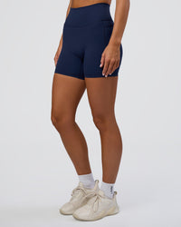 Woman wearing Fusion Ultra High-Rise 6" Short Pockets - Future Navy | Model:Amity | Size:S