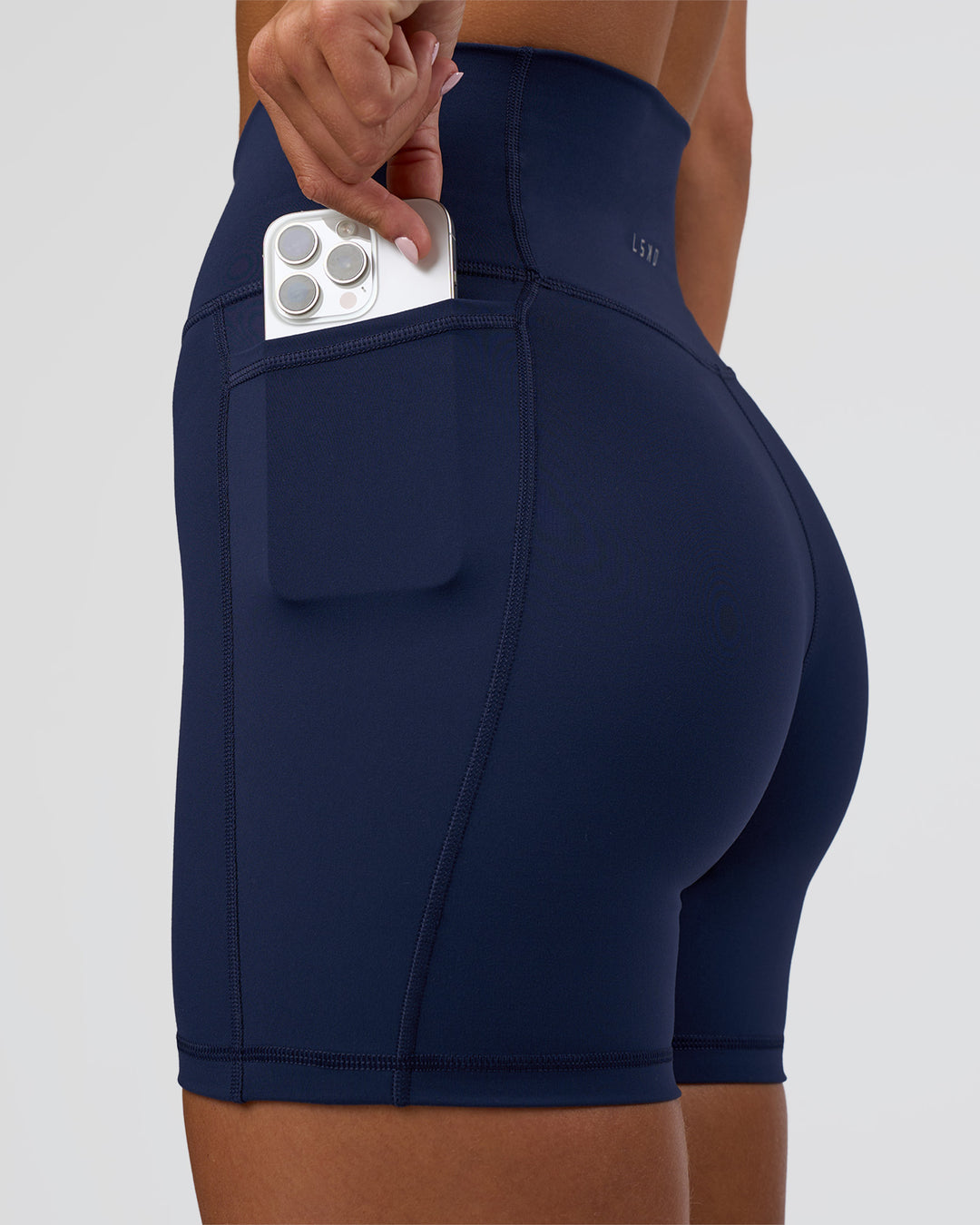 Woman wearing Fusion Ultra High-Rise 6&quot; Short Pockets - Future Navy | Model:Amity | Size:S