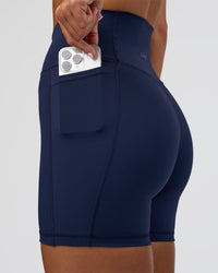 Woman wearing Fusion Ultra High-Rise 6" Short Pockets - Future Navy | Model:Amity | Size:S