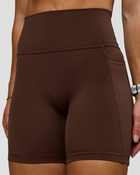 Woman wearing Fusion Ultra High-Rise 6" Short Pockets - Hot Chocolate | Model:Summer | Size:S