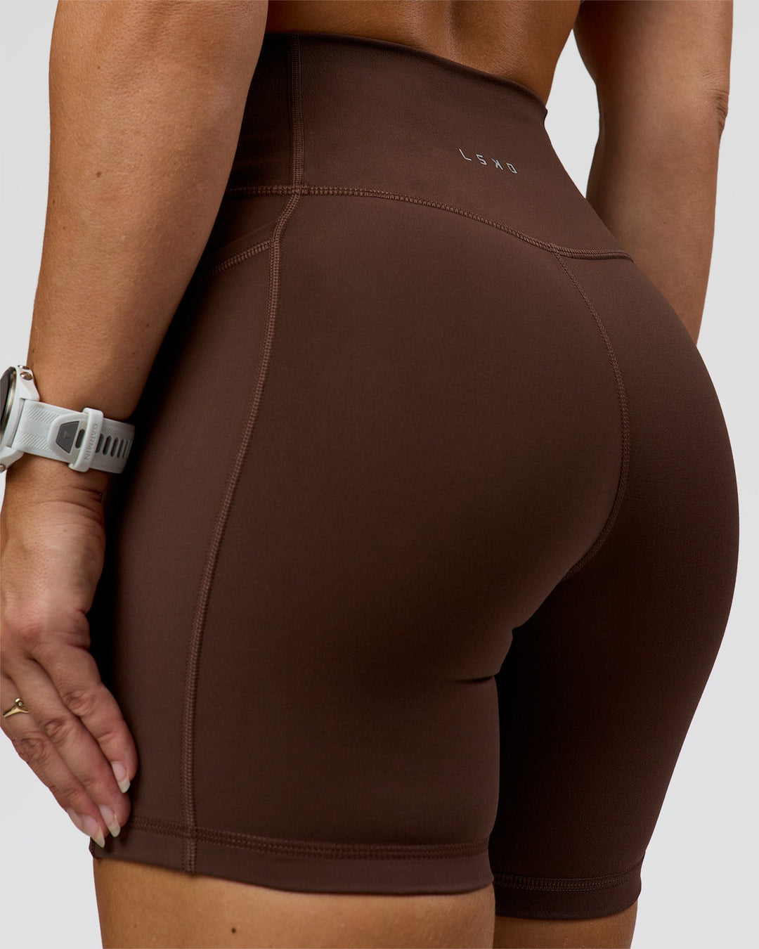 Woman wearing Fusion Ultra High-Rise 6" Short Pockets - Hot Chocolate | Model:Summer | Size:S