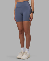 Woman wearing Fusion Ultra High-Rise 6" Short Pockets - Night Shadow | Set:true | Angle:side | Model:Rhiley | Size:S