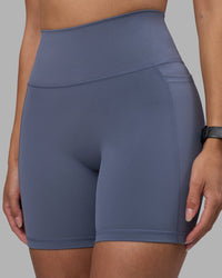 Woman wearing Fusion Ultra High-Rise 6" Short Pockets - Night Shadow | Model:Rhiley | Size:S