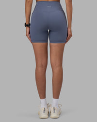 Woman wearing Fusion Ultra High-Rise 6" Short Pockets - Night Shadow | Set:true | Angle:back | Model:Rhiley | Size:S