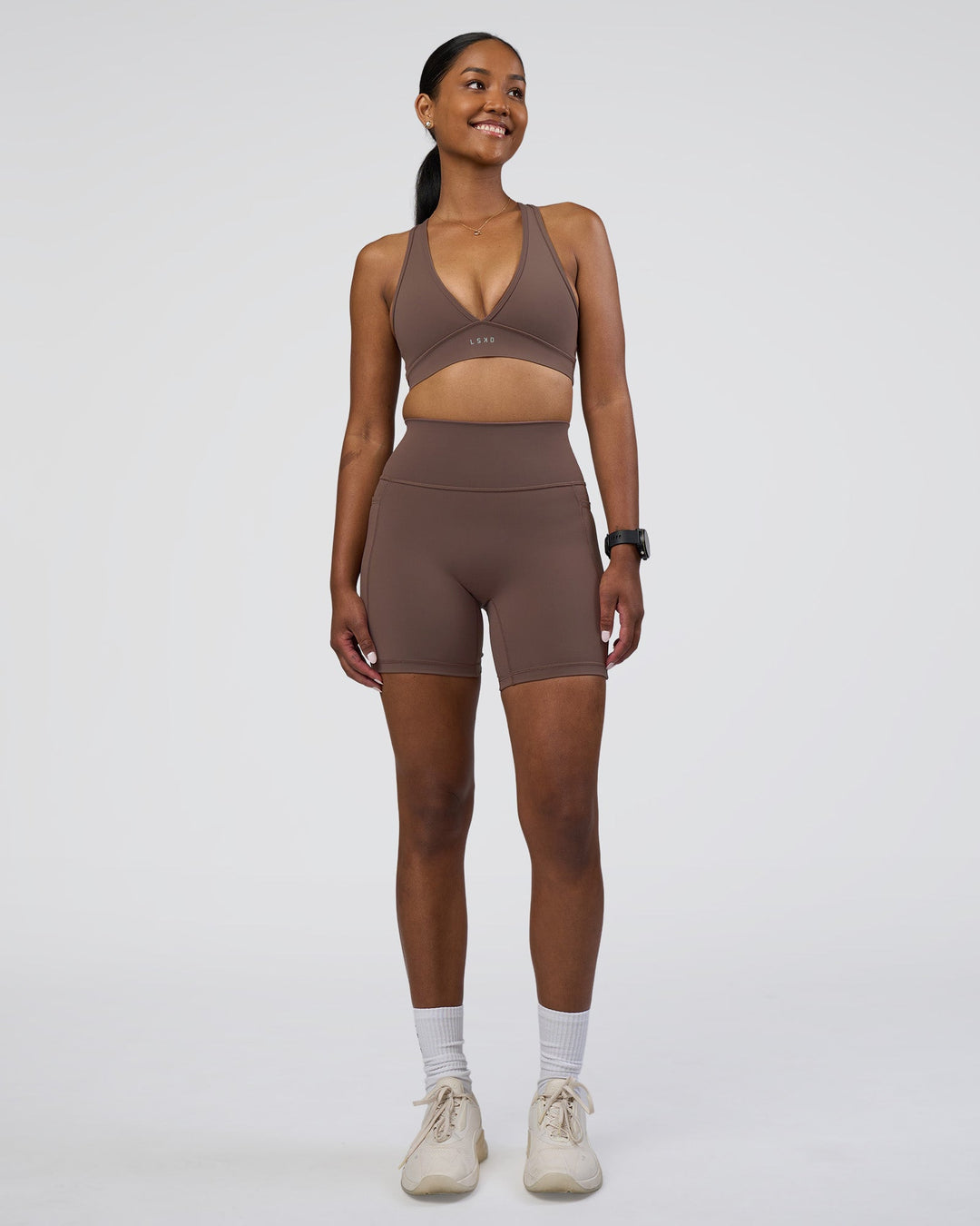 Woman wearing Fusion Ultra High-Rise 6&quot; Short Pockets - Peppercorn | Model:Rica | Size:S