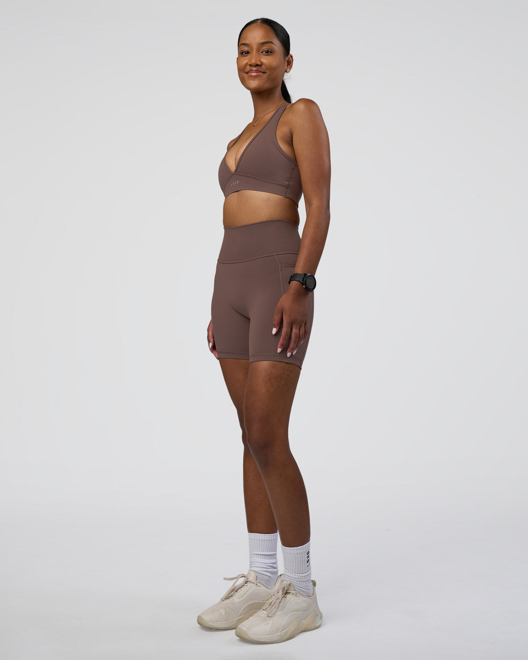 Woman wearing Fusion Ultra High-Rise 6&quot; Short Pockets - Peppercorn | Model:Rica | Size:S