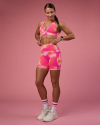 Woman wearing Fusion Ultra High-Rise 6" Short Pockets - Pink Glow Print | Model:Hannah | Size:S