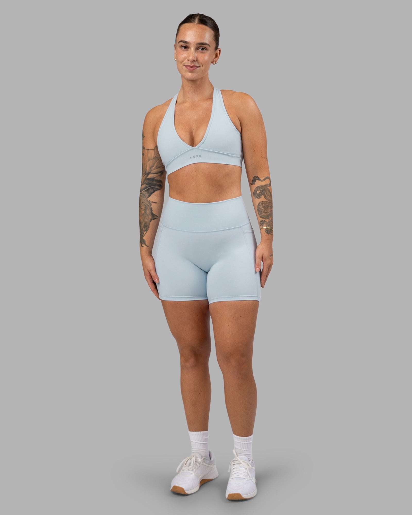 Woman wearing Fusion Ultra High-Rise 6" Short Pockets - Skyride| Model:Robyn | Size:S