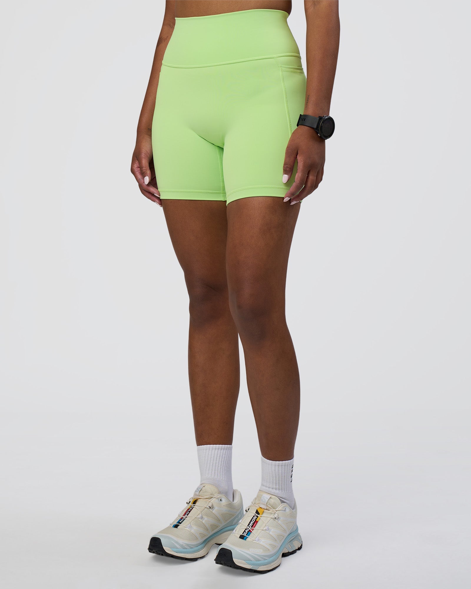 Woman wearing Fusion Ultra High-Rise 6" Short Pockets - Solar Lime | Model:Rica | Size:S