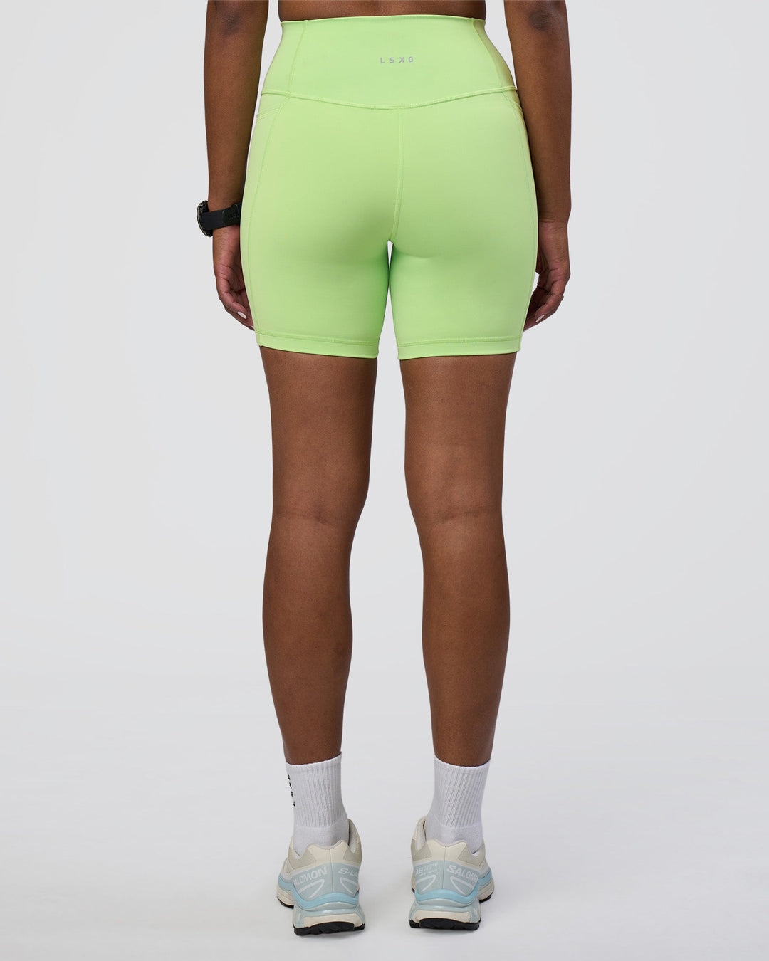 Woman wearing Fusion Ultra High-Rise 6&quot; Short Pockets - Solar Lime | Model:Rica | Size:S