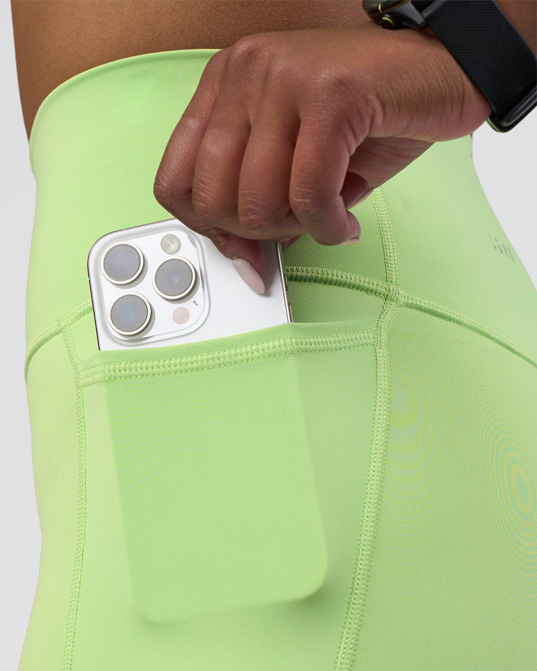 Woman wearing Fusion Ultra High-Rise 6&quot; Short Pockets - Solar Lime | Model:Rica | Size:S