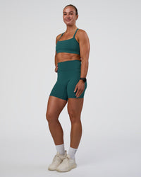 Woman wearing Fusion Ultra High-Rise 6" Short Pockets - Transformative Teal | Model:Sav | Size:S
