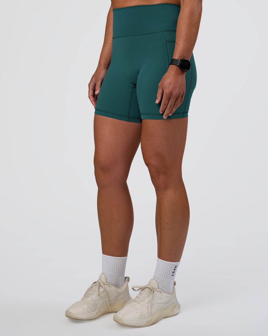 Woman wearing Fusion Ultra High-Rise 6" Short Pockets - Transformative Teal | Set:true | Angle:side | Model:Sav | Size:S