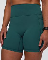 Woman wearing Fusion Ultra High-Rise 6" Short Pockets - Transformative Teal | Model:Sav | Size:S