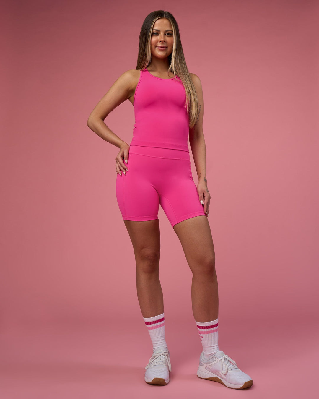 Woman wearing Fusion Ultra High-Rise 6&quot; Short Pockets - Ultra Pink | Model:Tianah | Size:S