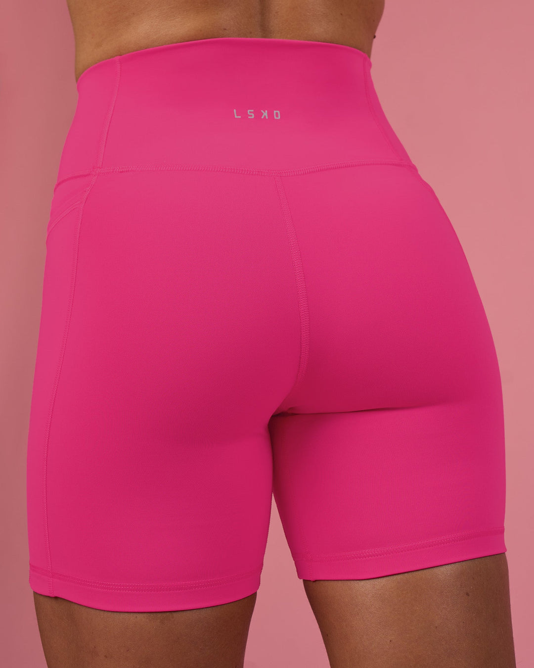 Woman wearing Fusion Ultra High-Rise 6&quot; Short Pockets - Ultra Pink | Model:Hannah | Size:S