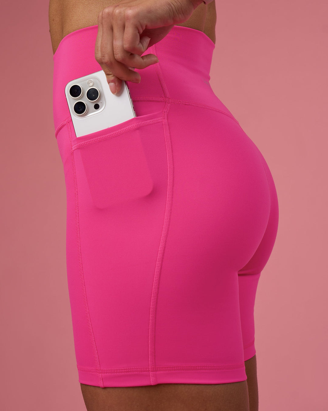 Woman wearing Fusion Ultra High-Rise 6&quot; Short Pockets - Ultra Pink | Model:Hannah | Size:S