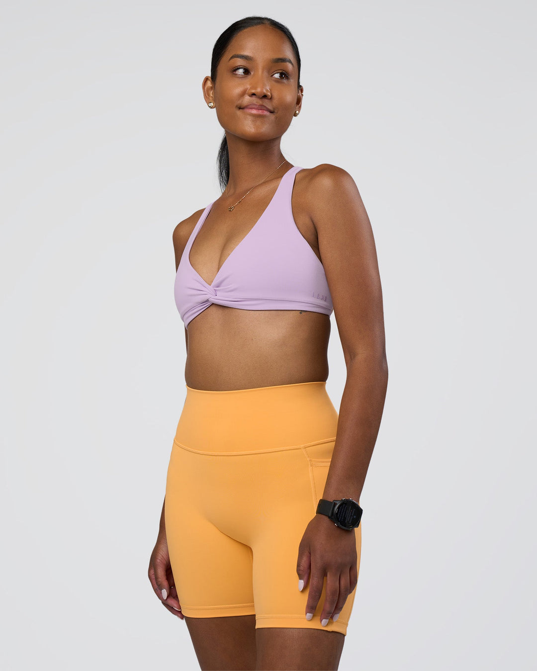 Woman wearing Fusion Ultra High-Rise 6&quot; Short Pockets - Warm Apricot | Model:Rica | Size:S