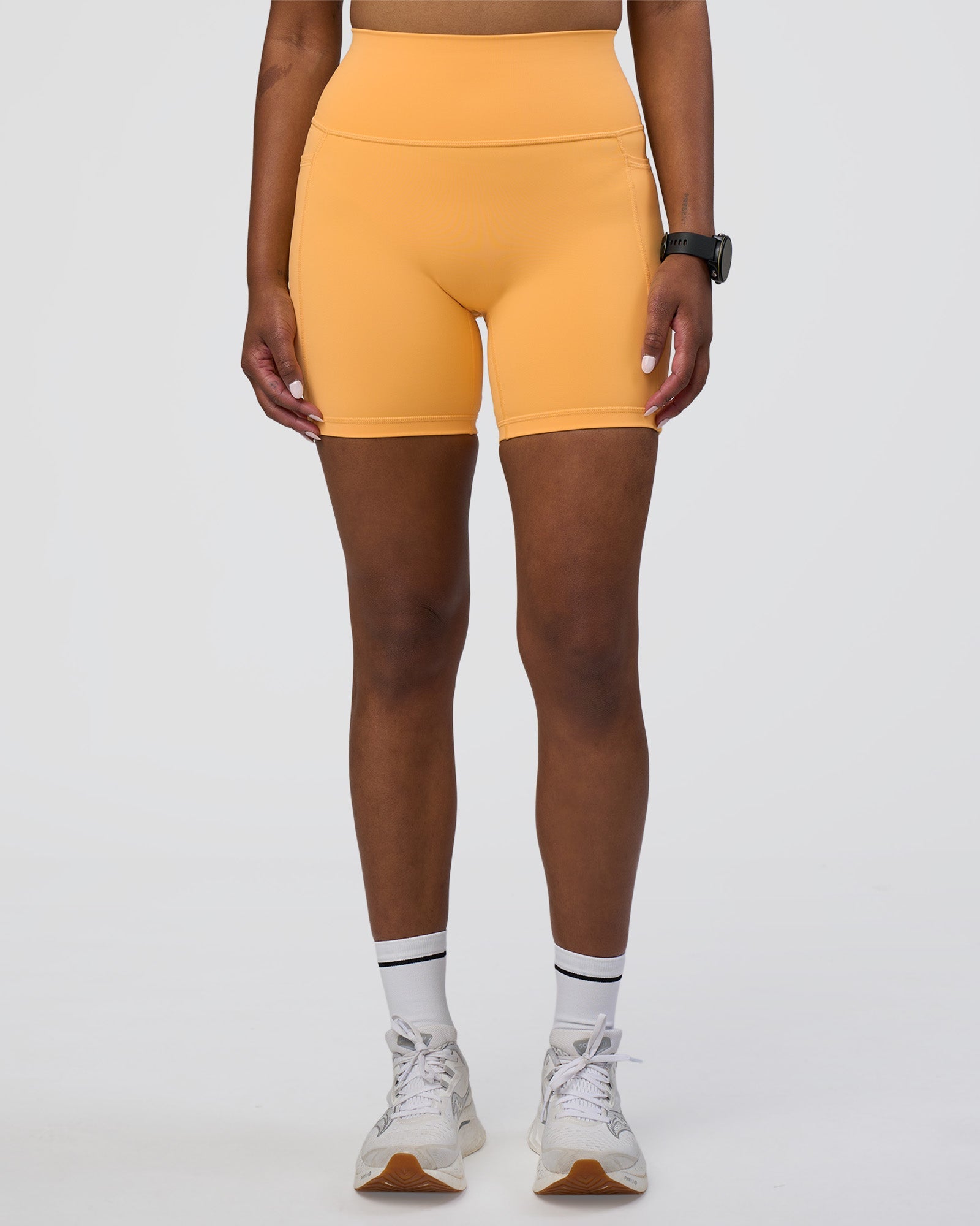 Woman wearing Fusion Ultra High-Rise 6" Short Pockets - Warm Apricot | Model:Rica | Size:S